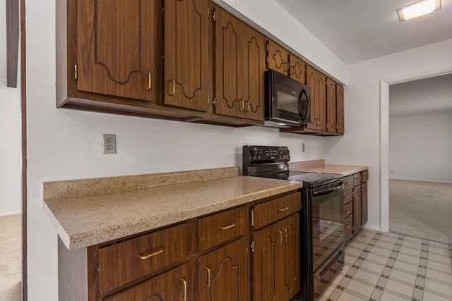 1204 Harrington Dr, Champaign, IL 61821 - kitchen featuring black appliances, light carpet, and light countertops