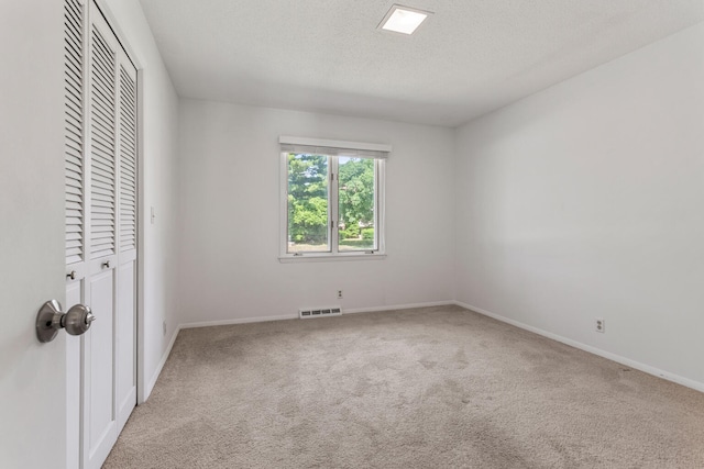 1204 Harrington Dr, Champaign, IL 61821 - unfurnished bedroom featuring carpet floors, a closet, and a textured ceiling