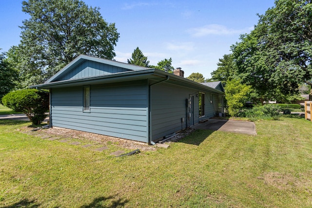 1204 Harrington Dr, Champaign, IL 61821 - view of side of home with a chimney and a lawn
