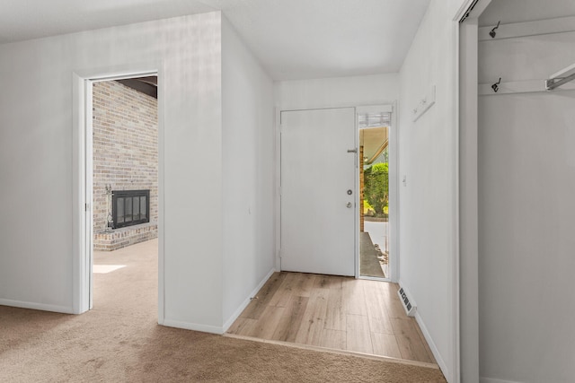 1204 Harrington Dr, Champaign, IL 61821 - carpeted entrance foyer with a brick fireplace and baseboards