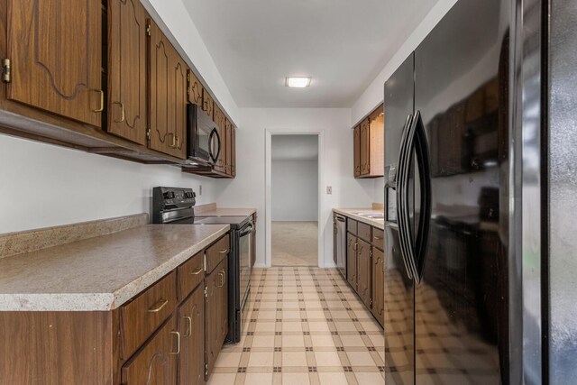 1204 Harrington Dr, Champaign, IL 61821 - kitchen with black appliances, light flooring, and light countertops