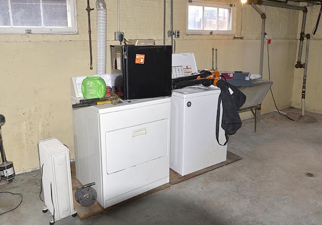 clothes washing area featuring independent washer and dryer