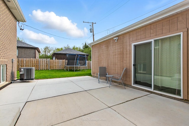 8566 S 83rd Ave, Hickory Hills, IL 60457 - view of patio featuring central AC unit, a trampoline, and a fenced backyard