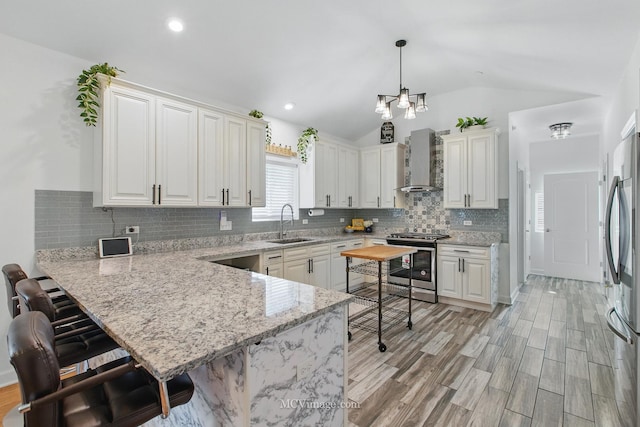 8566 S 83rd Ave, Hickory Hills, IL 60457 - kitchen with lofted ceiling, a sink, a peninsula, wall chimney exhaust hood, and appliances with stainless steel finishes
