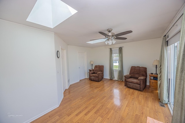 1315 Dellmar Ave, Joliet, IL 60435 - sitting room with a ceiling fan, a skylight, baseboards, and light wood-type flooring