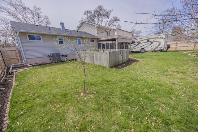 1315 Dellmar Ave, Joliet, IL 60435 - back of property with central AC, a balcony, a fenced backyard, a chimney, and a lawn