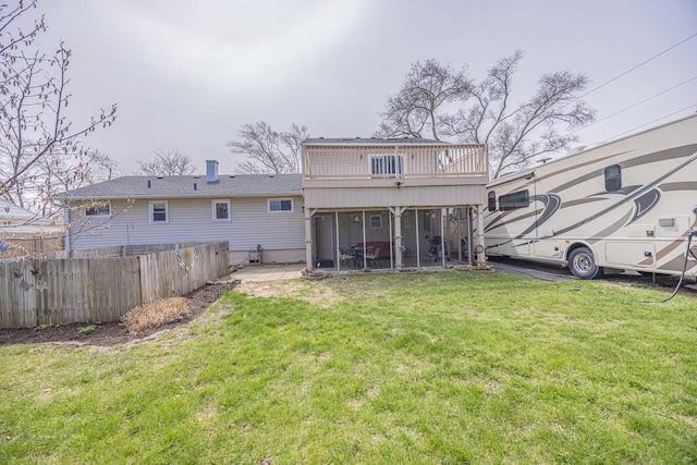 1315 Dellmar Ave, Joliet, IL 60435 - rear view of house with a lawn, fence, and a sunroom