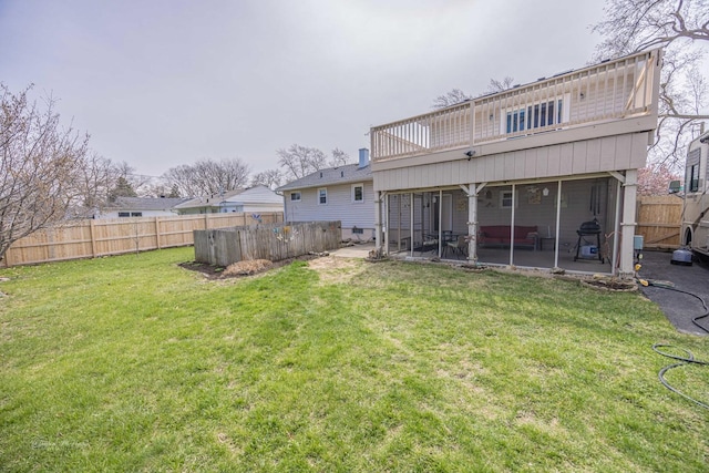 1315 Dellmar Ave, Joliet, IL 60435 - back of property featuring fence, a sunroom, a patio, and a lawn