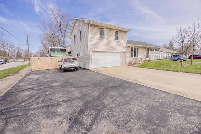 1315 Dellmar Ave, Joliet, IL 60435 - view of front of house featuring fence, an attached garage, and driveway