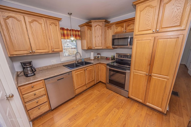1315 Dellmar Ave, Joliet, IL 60435 - kitchen featuring ornamental molding, a sink, light wood-style flooring, appliances with stainless steel finishes, and hanging light fixtures
