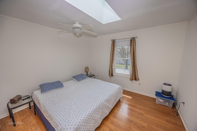 1315 Dellmar Ave, Joliet, IL 60435 - bedroom with a skylight, baseboards, ceiling fan, and light wood finished floors