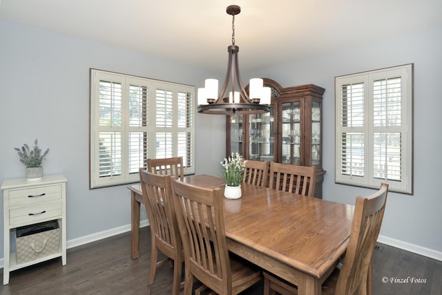 dining room with baseboards, a chandelier, and a healthy amount of sunlight