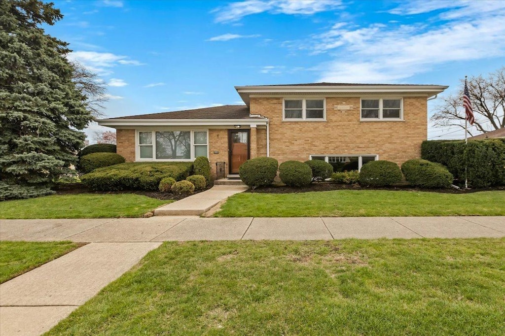 8932 Oriole Ave, Morton Grove, IL 60053 - tri-level home with brick siding and a front yard