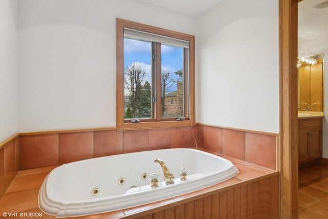 full bath featuring a jetted tub and vanity