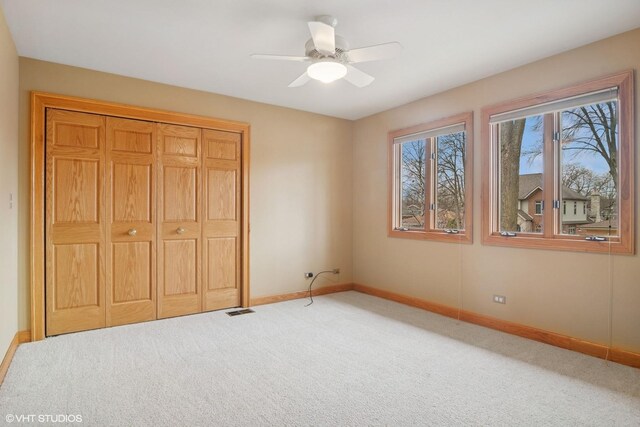 unfurnished bedroom featuring a closet, visible vents, carpet flooring, and baseboards