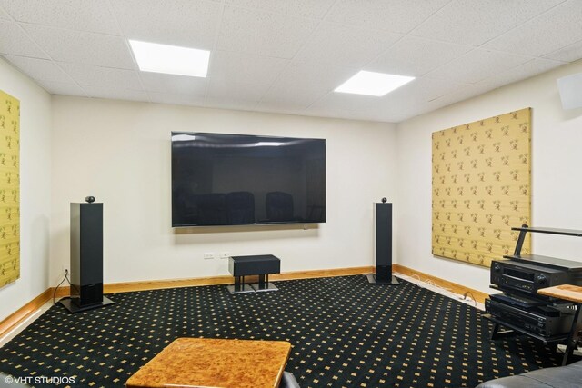 carpeted home theater room featuring baseboards
