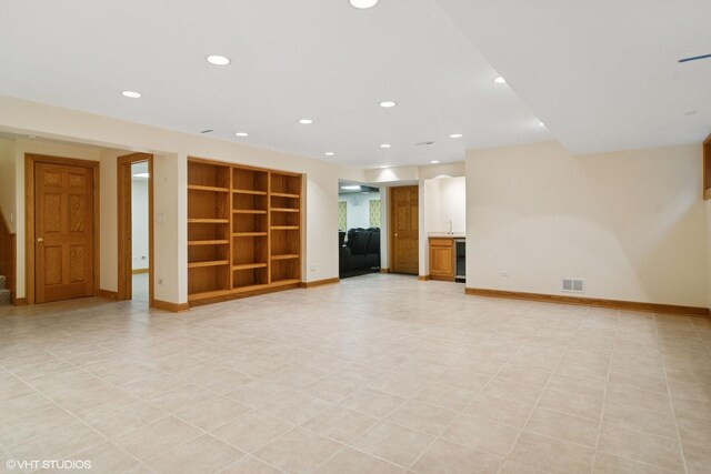 unfurnished living room with stairway, built in shelves, baseboards, visible vents, and recessed lighting