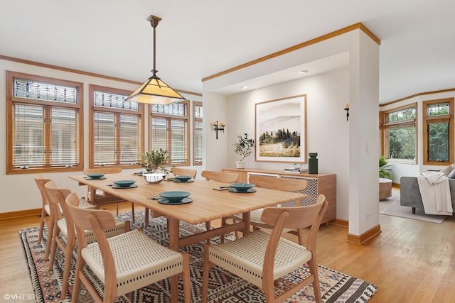 dining area with light wood finished floors and baseboards