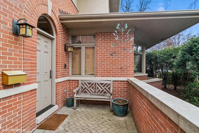 property entrance with brick siding