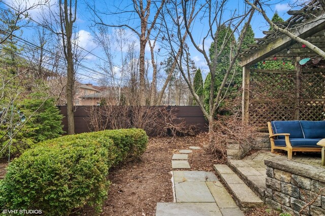 view of yard with fence, a pergola, and outdoor lounge area