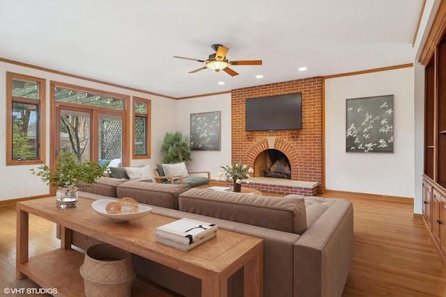 living room with a ceiling fan, wood finished floors, baseboards, a brick fireplace, and recessed lighting