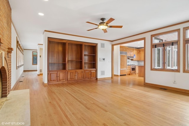 unfurnished living room featuring light wood finished floors, baseboards, visible vents, ceiling fan, and ornamental molding