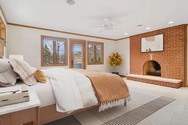 carpeted bedroom featuring a ceiling fan, crown molding, a brick fireplace, and recessed lighting