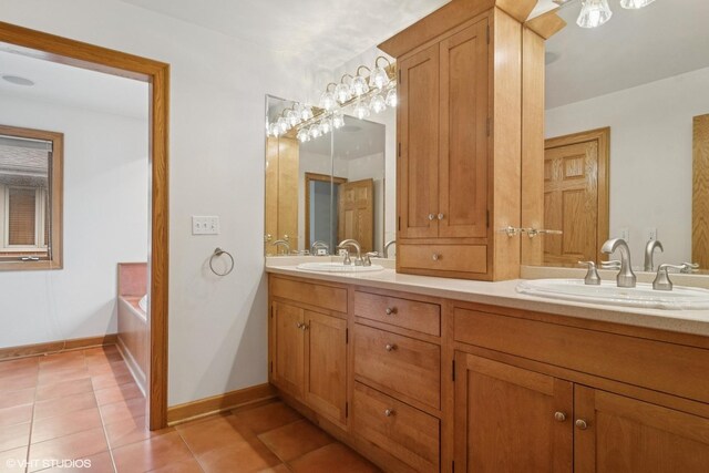 full bathroom featuring double vanity, a garden tub, tile patterned floors, and a sink