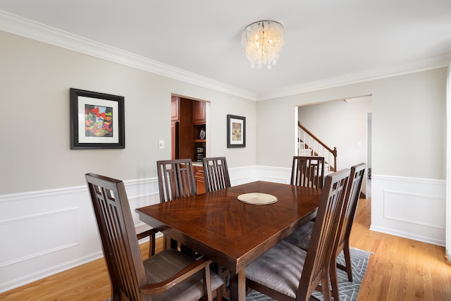 925 Appomattox Cir, Naperville, IL 60540 - dining space featuring crown molding, wainscoting, stairway, a chandelier, and light wood-style flooring