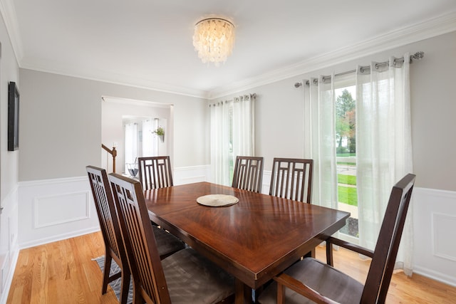 925 Appomattox Cir, Naperville, IL 60540 - dining room featuring a decorative wall, a chandelier, light wood-style flooring, a wainscoted wall, and ornamental molding