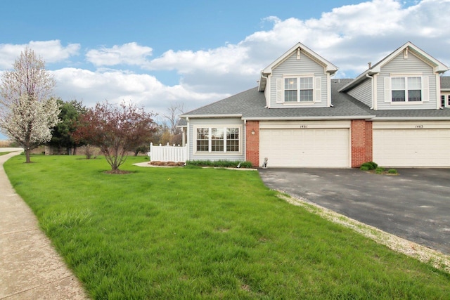 1461 S Candlestick Way, Waukegan, IL 60085 - view of front facade featuring a front lawn, brick siding, driveway, roof with shingles, and an attached garage