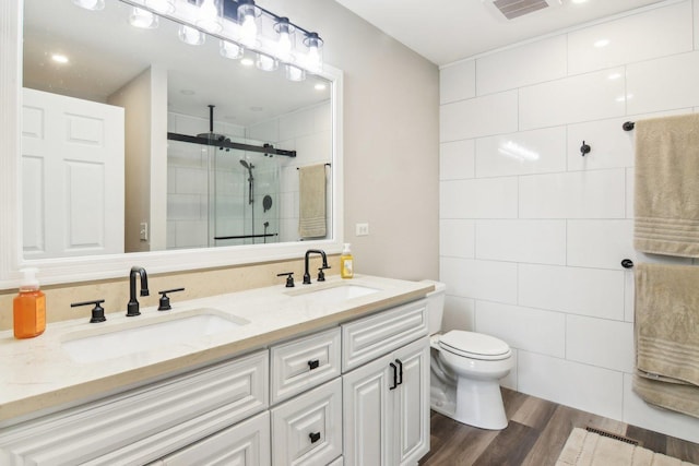 1461 S Candlestick Way, Waukegan, IL 60085 - bathroom with a stall shower, a sink, wood finished floors, and visible vents