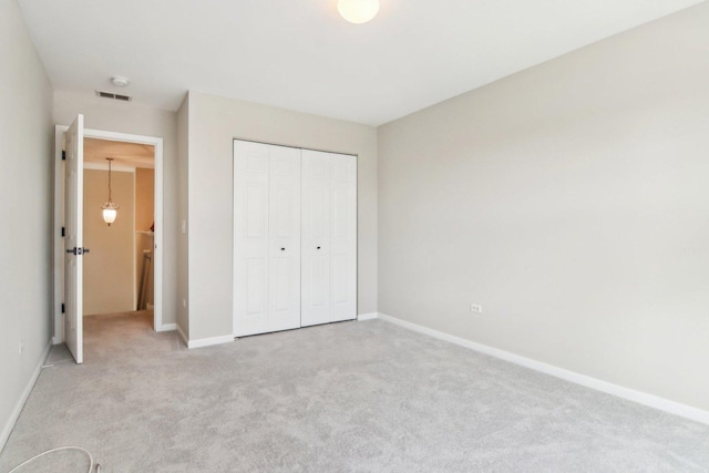 1461 S Candlestick Way, Waukegan, IL 60085 - unfurnished bedroom with light colored carpet, visible vents, a closet, and baseboards