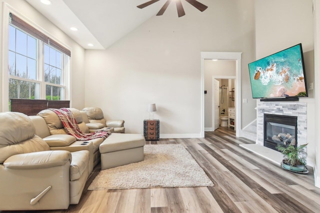 1461 S Candlestick Way, Waukegan, IL 60085 - living room featuring recessed lighting, wood finished floors, a stone fireplace, high vaulted ceiling, and a ceiling fan