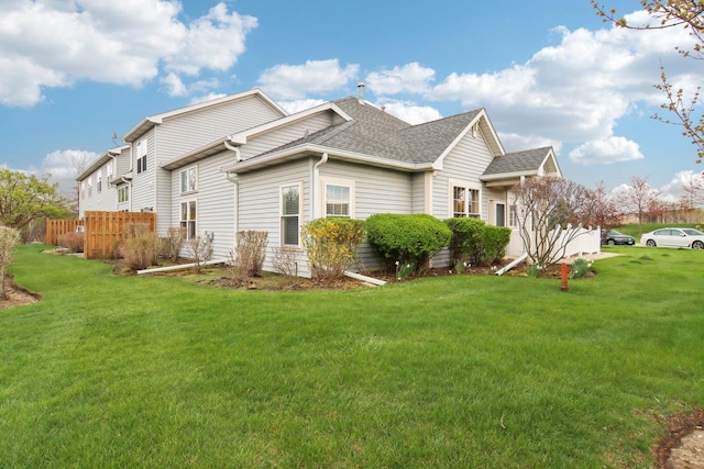 1461 S Candlestick Way, Waukegan, IL 60085 - view of side of property featuring a lawn, fence, and a shingled roof