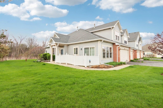 1461 S Candlestick Way, Waukegan, IL 60085 - back of property featuring a garage, aphalt driveway, a yard, and roof with shingles