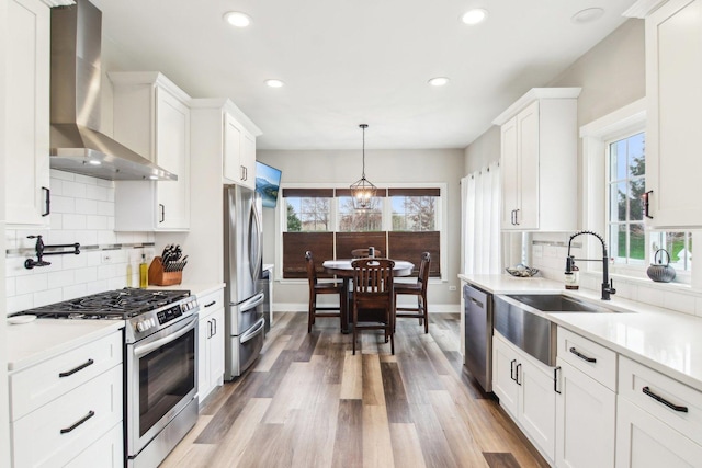 1461 S Candlestick Way, Waukegan, IL 60085 - kitchen with appliances with stainless steel finishes, white cabinetry, wall chimney range hood, and a sink