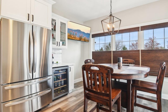 1461 S Candlestick Way, Waukegan, IL 60085 - dining room featuring light wood finished floors, a wealth of natural light, a chandelier, and beverage cooler