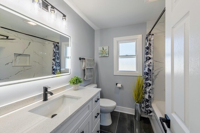 full bathroom featuring shower / bath combination with curtain, baseboards, vanity, and toilet