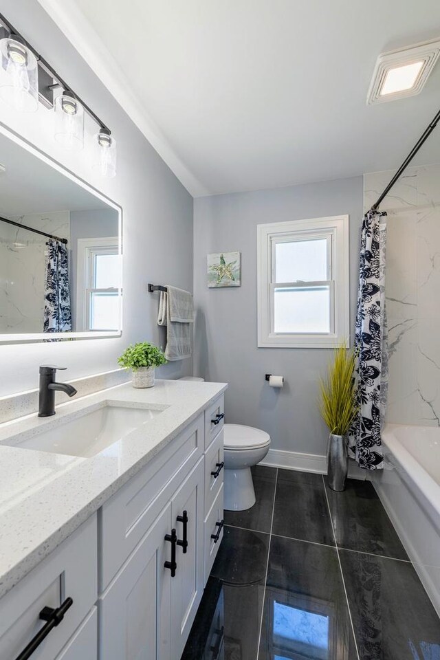 full bath featuring toilet, vanity, and tile patterned floors