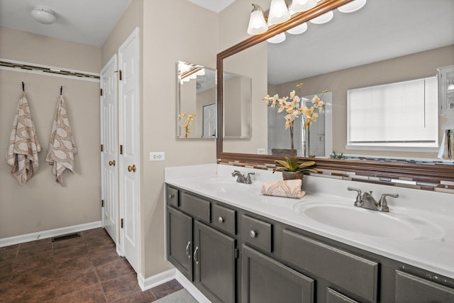 3 Spring Garden Ct, Lake In The Hills, IL 60156 - bathroom featuring double vanity, baseboards, and a shower