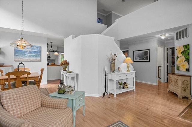 3 Spring Garden Ct, Lake In The Hills, IL 60156 - living area with baseboards, light wood-style flooring, and crown molding