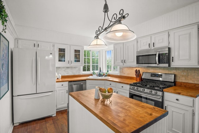 3 Spring Garden Ct, Lake In The Hills, IL 60156 - kitchen featuring butcher block countertops, appliances with stainless steel finishes, a sink, white cabinetry, and ornamental molding