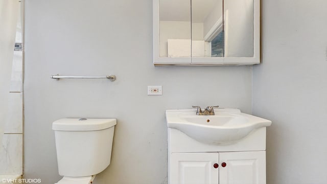 bathroom featuring toilet and vanity