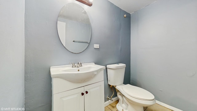 bathroom with tile patterned floors, baseboards, toilet, and vanity