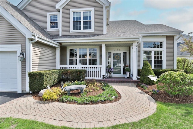 doorway to property featuring a shingled roof and a porch