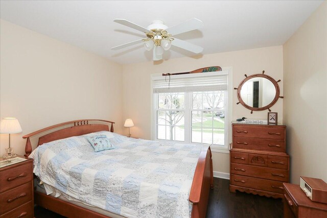 bedroom featuring ceiling fan and dark wood-type flooring