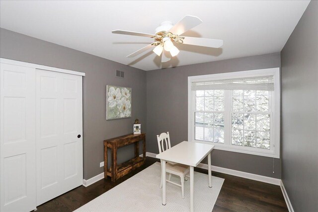 home office featuring baseboards, visible vents, and dark wood-type flooring