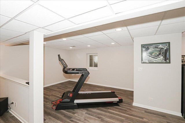 exercise area featuring baseboards, recessed lighting, and wood finished floors