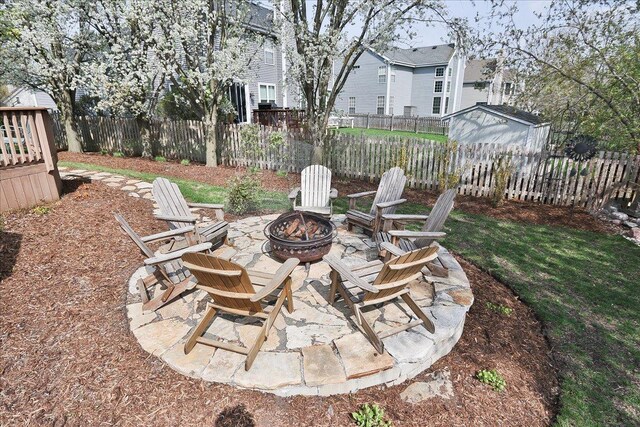 view of yard featuring a patio, a fenced backyard, and a fire pit